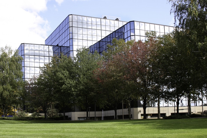 building exterior with lawn and trees